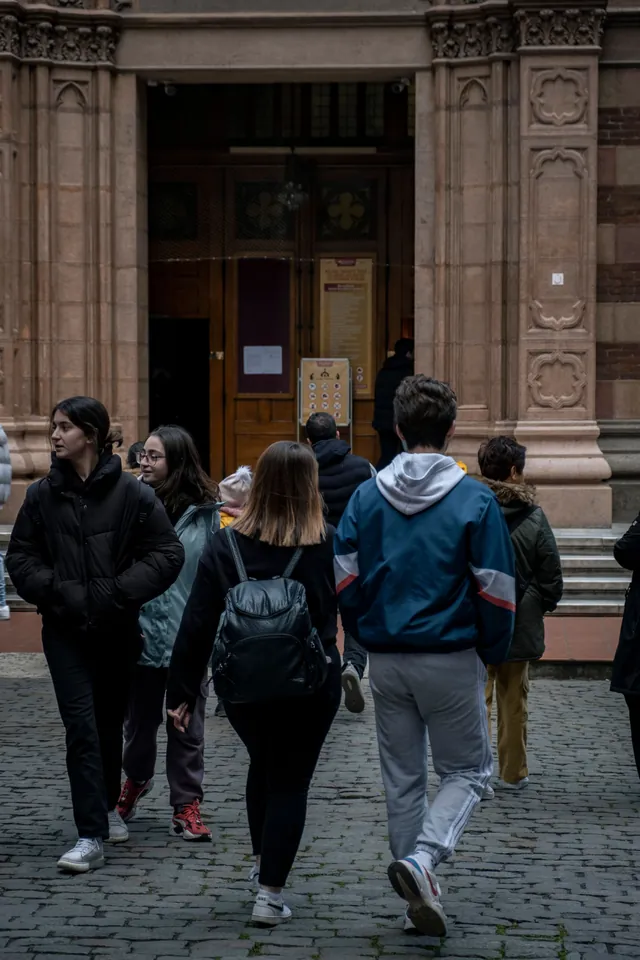 Des élèves entrent dans leur établissement par la porte principale